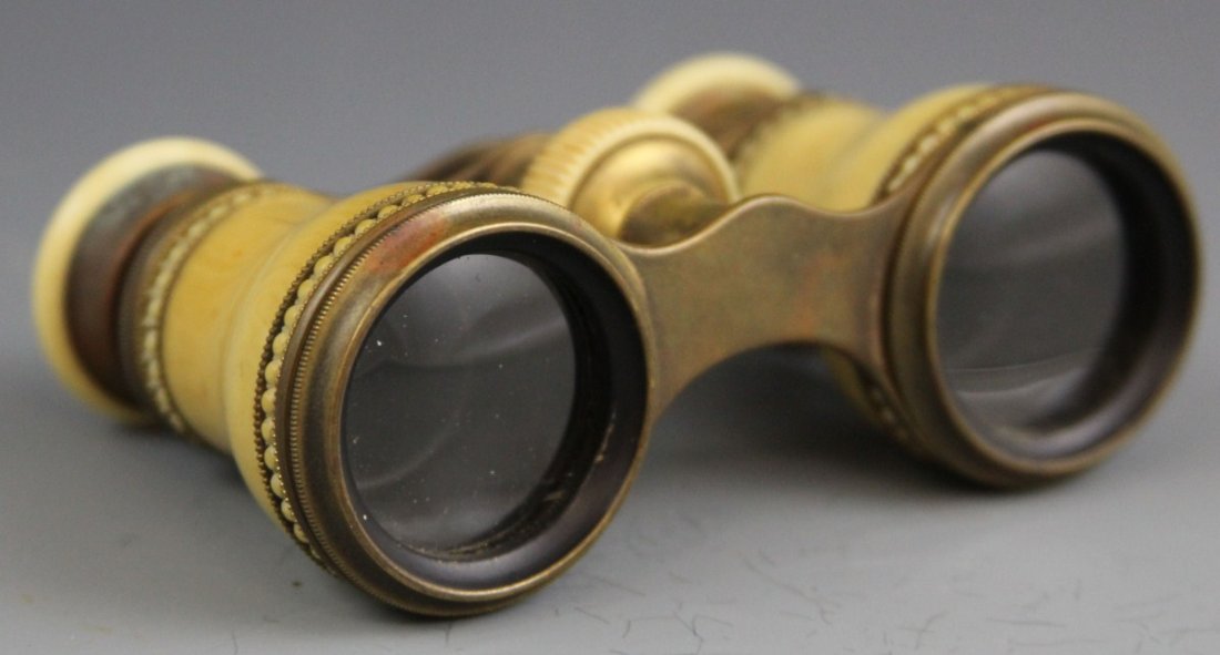 IVORY AND BRASS OPERA GLASSES: IVORY AND BRASS OPERA GLASSES 19th C. ivory and brass adjustable opera glasses. Some damage is visible on the ivory components, however the glass is completely intact. 177.5g 4 x 2.5"