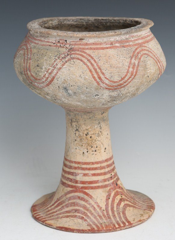 ANCIENT BAN CHIANG PAINTED FOOTED VESSEL: ANCIENT BAN CHIANG PAINTED FOOTED VESSEL Ancient Ban Chiang (Northern Thailand) Neolithic Period 1000-500 B.C. footed pottery vessel of globular form with flared rim and painted linear scrolling motif