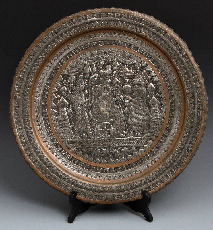 Embossed Persian Bronze Charger: EMBOSSED PERSIAN BRONZE CHARGER A large Persian bronze charger, embossed with scene of King, on a Persian throne, wearing turban, and receiving gifts. Size: 15"