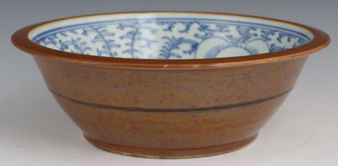 19TH CENTURY CHINESE EARTHENWARE BOWL: 19TH CENTURY CHINESE EARTHENWARE BOWL A Chinese Qing dynasty brown glazed earthenware bowl with blue and white interior. Size: 11" across
