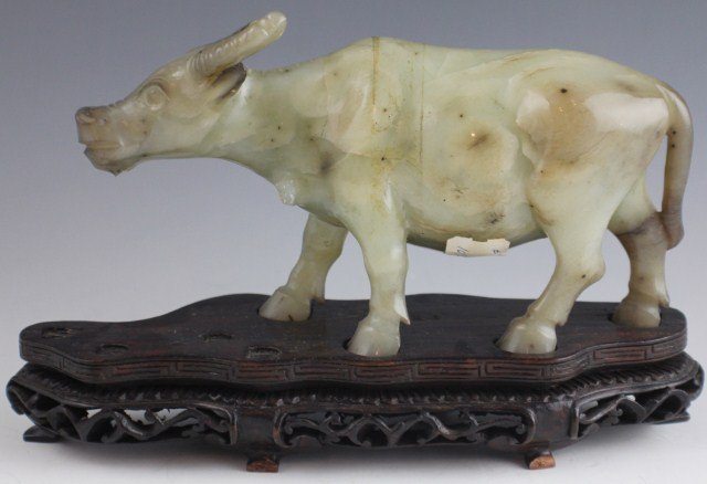 CHINESE CELADON GREEN CARVED FIGURE OF AN OX