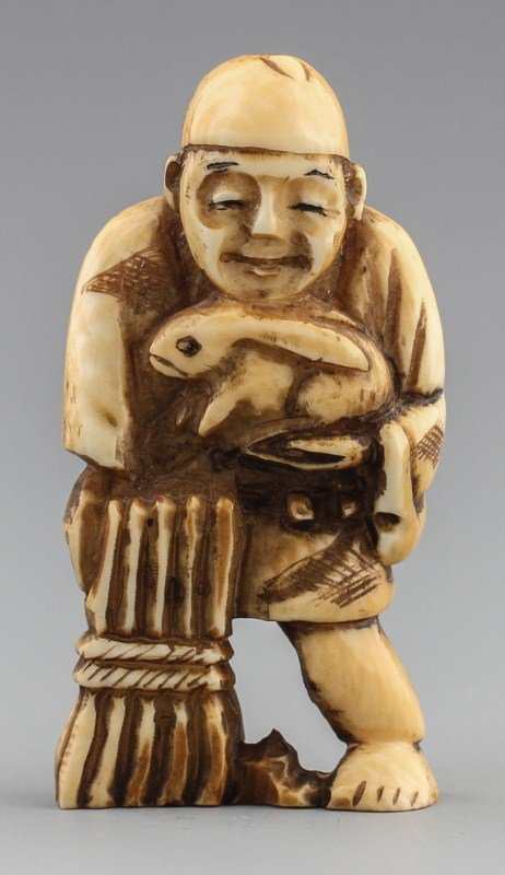 JAPANESE CARVED IVORY NETSUKE MAN WITH HARE: JAPANESE CARVED IVORY NETSUKE MAN WITH HARE Japanese carved ivory netsuke figure of man with hare and wheat. Signed. Size: 2 x 1 x .25" Weight: 15g