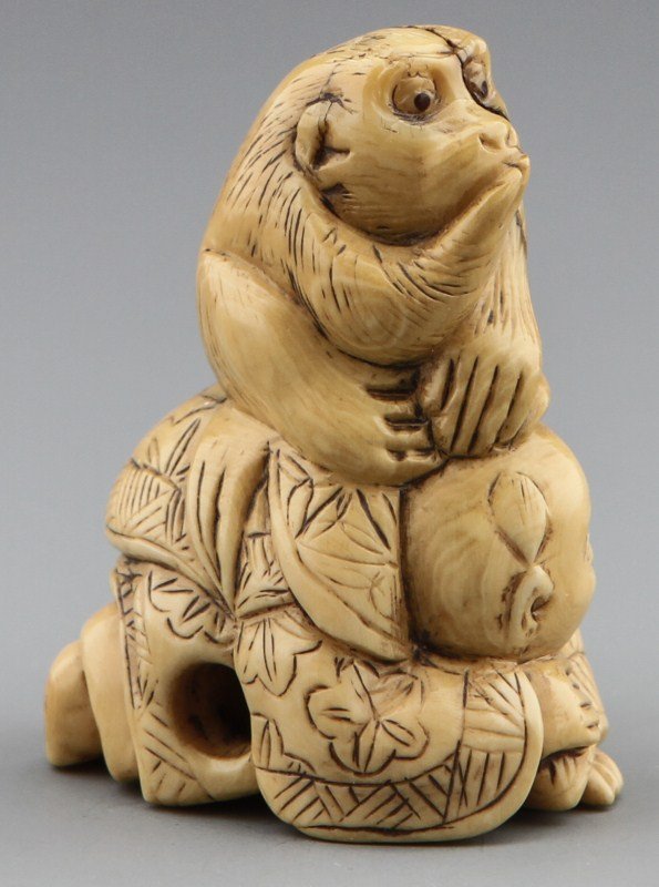 JAPANESE CARVED IVORY NETSUKE OF MAN AND MONKEY