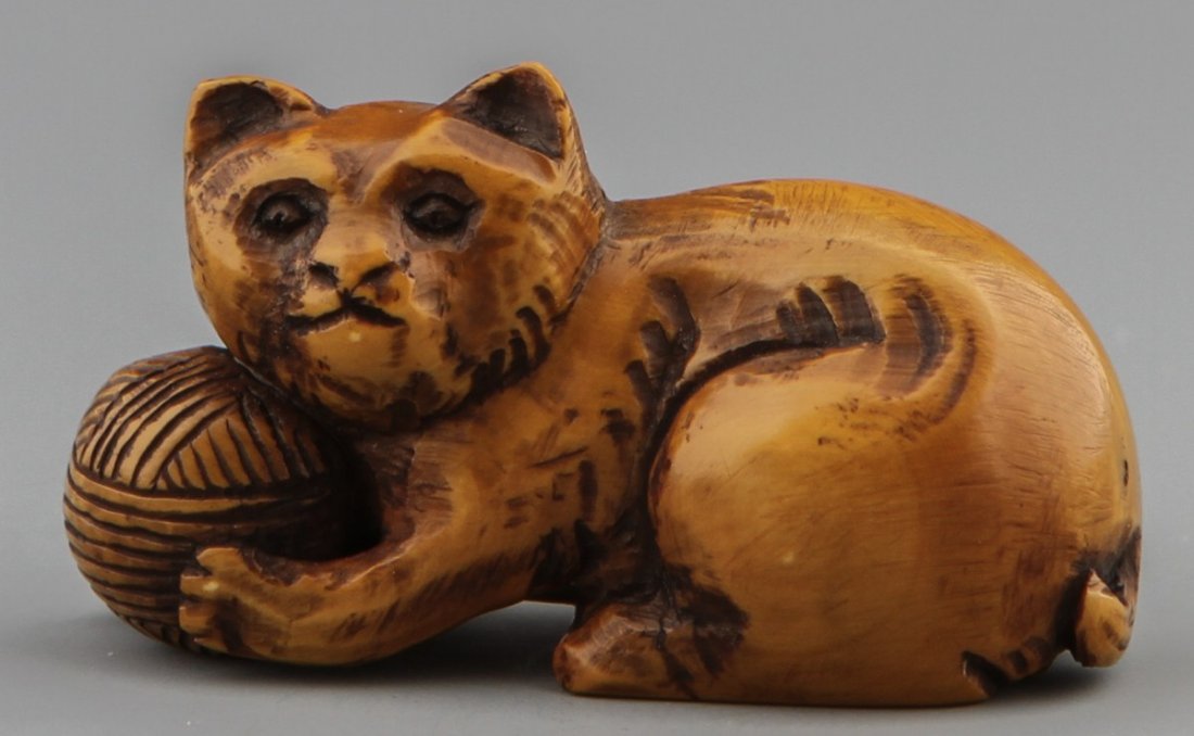 JAPANESE CARVED IVORY NETSUKE FELINE AND YARN