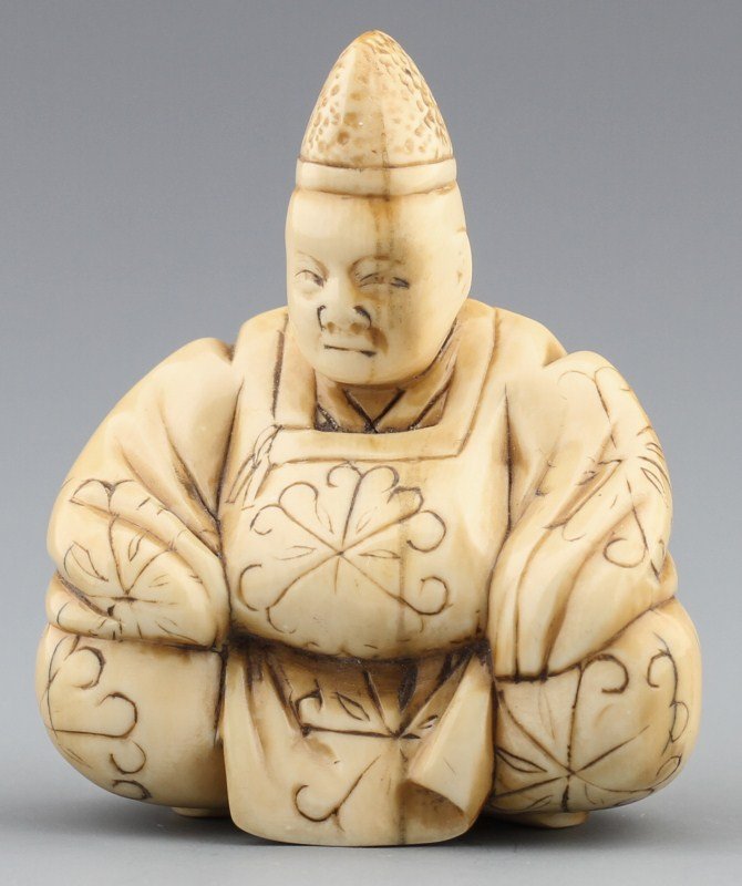 JAPANESE CARVED IVORY NETSUKE OF A SITTING MONK