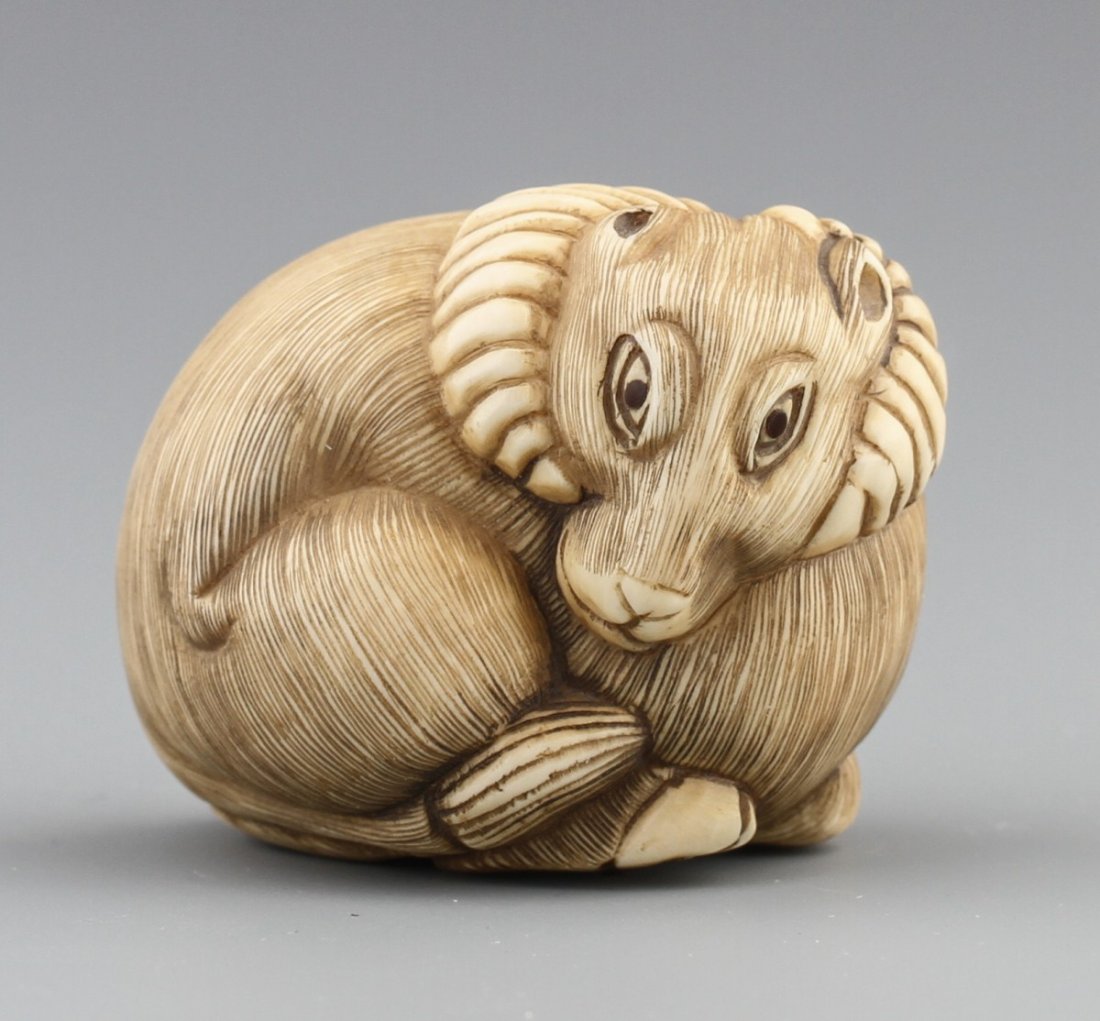 JAPANESE CARVED IVORY NETSUKE RAM: JAPANESE CARVED IVORY NETSUKE RAM A Japanese ivory netsuke of a resting ram signed Baisho on base. Very good detail. Size: 1.5 x 1.75" Weight: 41.2g
