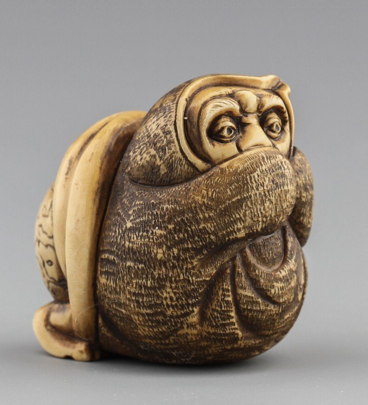 JAPANESE CARVED IVORY NETSUKE WOMAN AND BLANKET