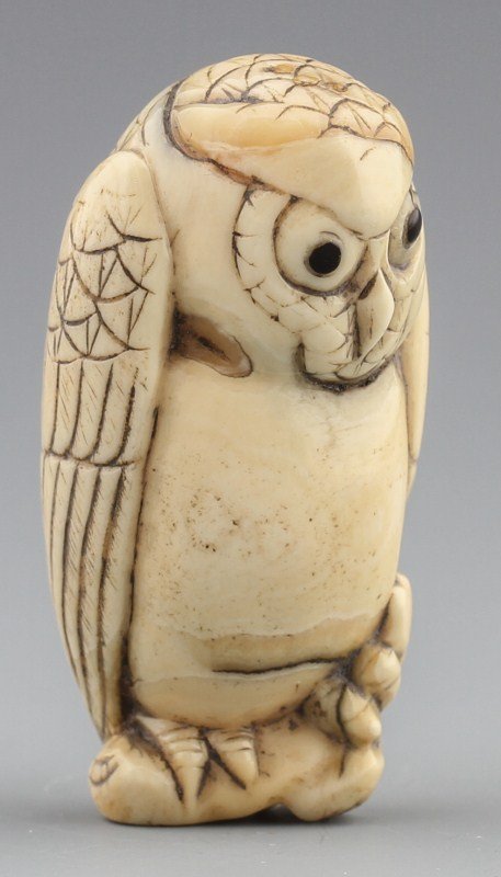 JAPANESE CARVED IVORY NETSUKE OWL: JAPANESE CARVED IVORY NETSUKE OWL Japanese carved ivory netsuke figure of tan owl. Signed. Size: 2 x 1 x .75" Weight: 31g