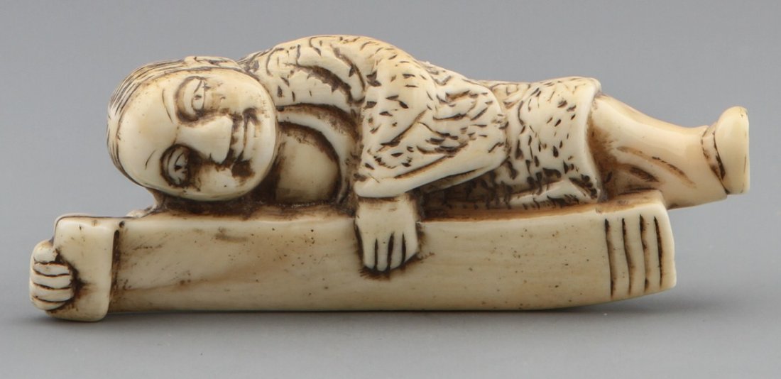 JAPANESE CARVED IVORY NETSUKE MAN WITH SCROLL