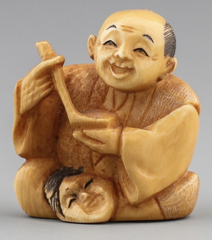JAPANESE CARVED IVORY NETSUKE MAN WITH MASK