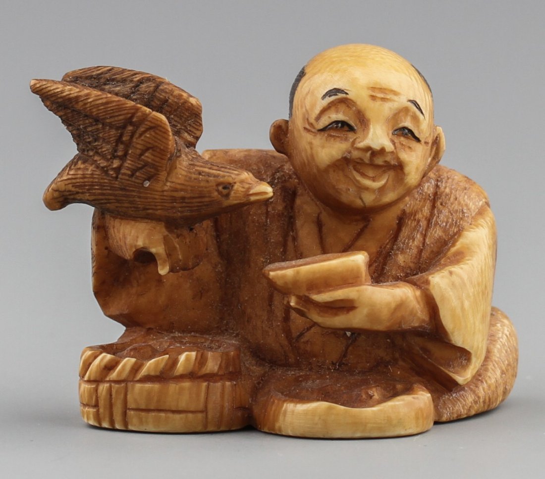 JAPANESE CARVED IVORY NETSUKE ELDER FEEDING EAGLE