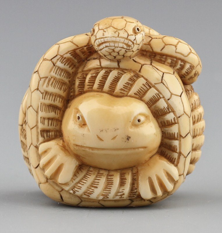 JAPANESE CARVED IVORY NETSUKE FROG & SNAKE: JAPANESE CARVED IVORY NETSUKE FROG & SNAKE Japanese carved ivory netsuke figure of a frog being strangled by a snake. Signed on bottom, Tohru. Size: 1.5 x 1.25 x 1.25" Weight: 33.1g