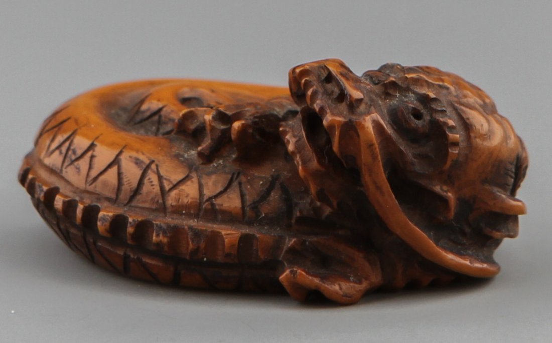 JAPANESE CARVED IVORY NETSUKE CURLED DRAGON
