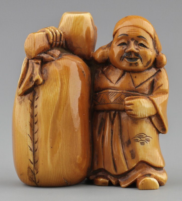 JAPANESE CARVED IVORY NETSUKE DIAKOKU: JAPANESE CARVED IVORY NETSUKE DIAKOKU Japanese carved ivory netsuke figure of diakoku. Signed on bottom. Stained. Size: 2 x 1.75 x 1" Weight: 56.2g