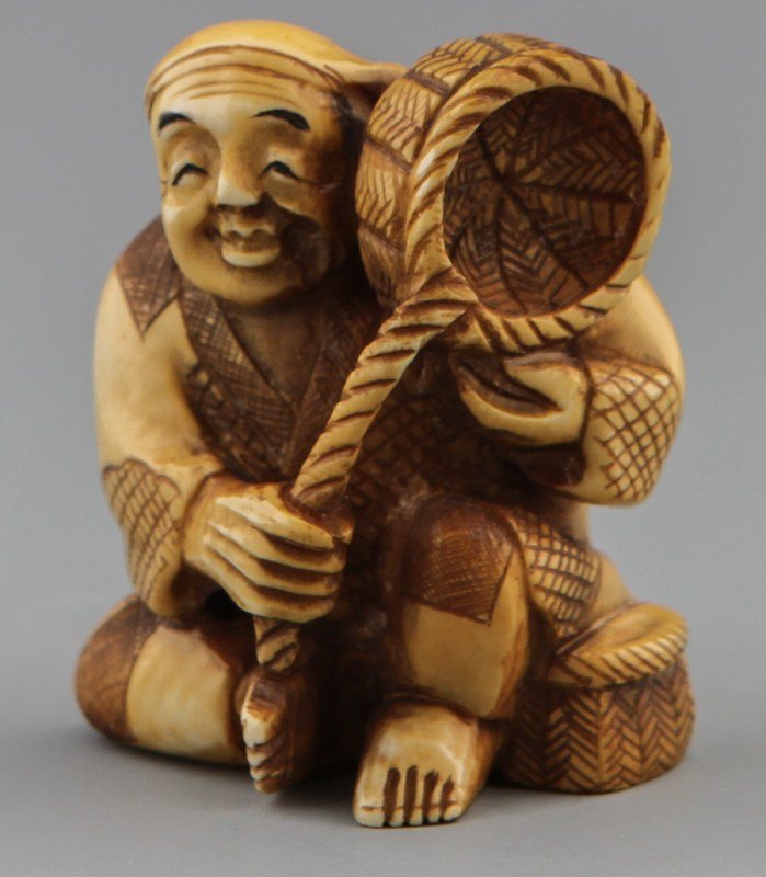 JAPANESE CARVED IVORY NETSUKE OF BASKET MAN