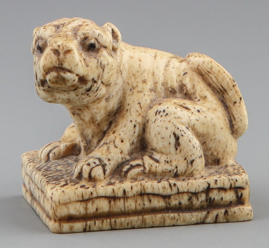 JAPANESE CARVED IVORY NETSUKE OF FOO DOG STAMP