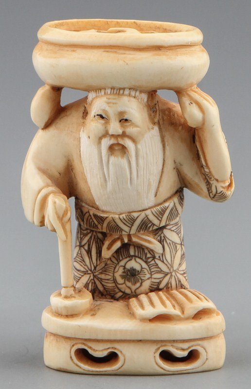 JAPANESE CARVED IVORY NETSUKE ELDER WITH BASKET