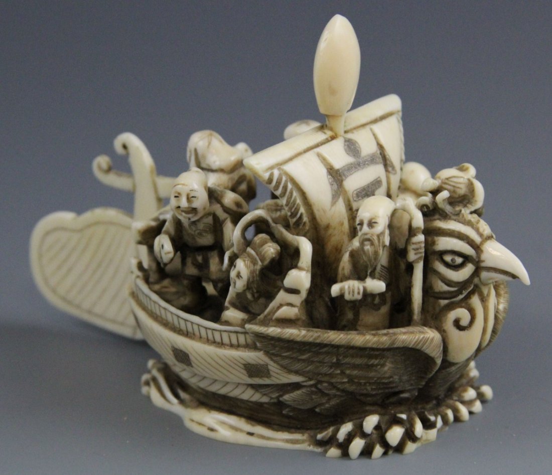 JAPANESE CARVED IVORY NETSUKE SEVEN LUCKY GODS: JAPANESE CARVED IVORY NETSUKE SEVEN LUCKY GODS A Japanese carved ivory netsuke featuring the seven lucky gods together in phoenix boat. Signature on bottom. 95.9g 4 x 2 x 2.75"