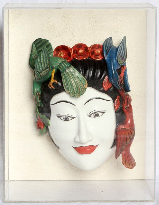 WOOD CARVED BALINESE MASK: WOOD CARVED BALINESE MASK Wood carved and vibrantly painted Balinese mask. Elegantly painted female face surrounded by three birds. Mounted and framed in acrylic box. Size: 17 x 22 x 7.5"