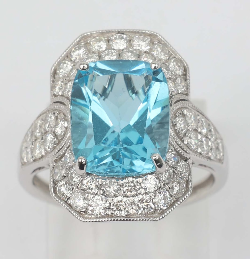 14K MICHAEL CHRISTOFF RING DIAMOND & BLUE TOPAZ: 14k Michael Christoff White Gold Ring Diamond and Blue Topaz. ring. 50 round diamonds Vs. clarity totaling 1.04ct and one scissor cut radiant blue topaz 4.83 ct. Size: 6.5 Weight: 4.3 grams 