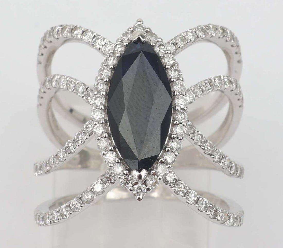 18K MICHAEL CHRISTOFF RING DIAMOND & BLUE SAPPHIRE: 18k Michael Christoff White Gold Ring Diamonds and intense dark blue sapphire. 102 brilliant round diamonds VS clarity totaling .92 ct accent a single 1.71 ct marquise shaped sapphire. Size: 6.5 