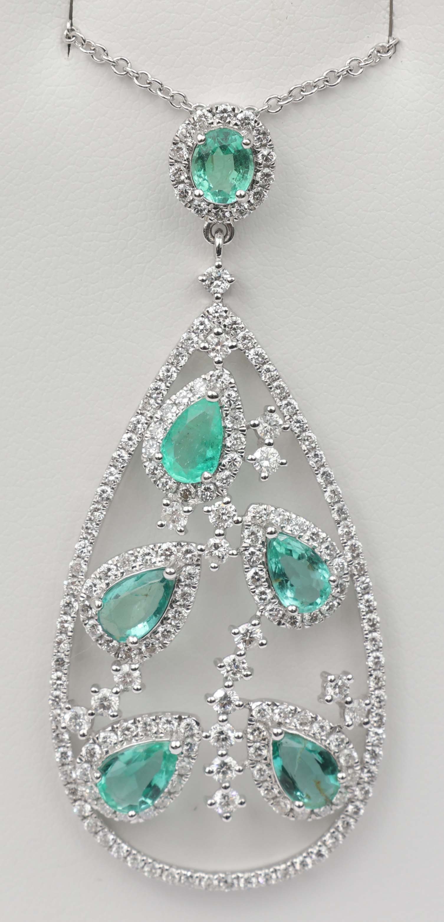 14K WHITE GOLD PENDANT DIAMOND & EMERALD: 14k White Gold Pendant Diamond and Emerald. 180 round diamonds totaling 1.66 ct. and six emeralds totaling 2.01 ct. Length: 18" Chain 2" Pendant Weight: 6.0 grams Must be paid by Certified