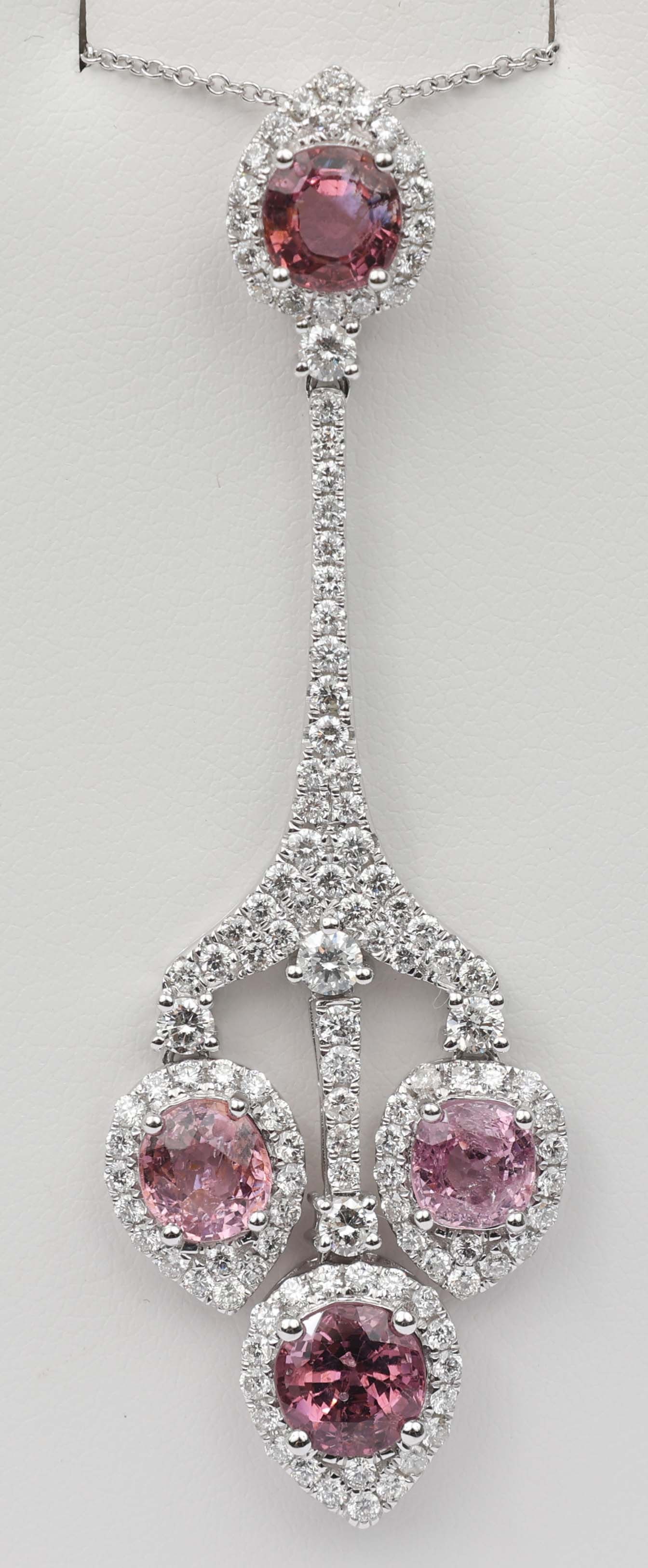 18K MICHAEL CHRISTOFF PDT.DIAMOND & PINK SAPPHIRE: 18k White Gold Michael Christoff Pendant Diamond & Pink Sapphire. 119 round diamonds totaling 1.87 ct and four pink sapphires 5.33 ct. total. Size / Length: 16" Chain 2.5" Pendant Weight: 9.1