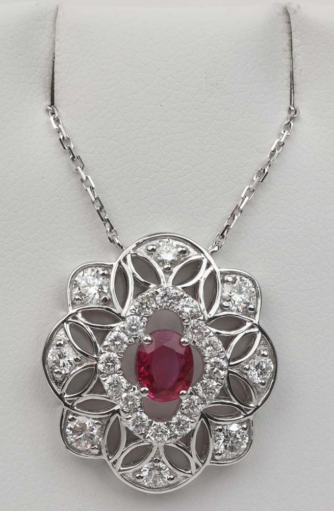18K GIA RUBY DIAMOND NECKLACE: 18K Natural GIA Ruby surrounded by White Diamonds Necklace. Natural Heat. 4x6mm 1 ct. accented by twenty four round diamonds totaling 1.14 ct. Length: 16" Chain. 1" Pendant. Weight: 5.7 G Must be