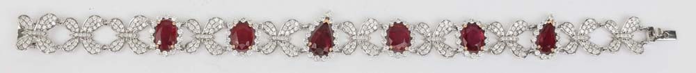 18K GIA CERTIFIED RUBY DIAMOND BRACELET BUTTERFLY: 18K White gold bracelet featuring natural GIA Rubies in Oval and Pear surrounded by white diamonds in butterfly motif. Six rubies 8.51 ct total, GIA certified natural Minor heated residue, 7x9mm