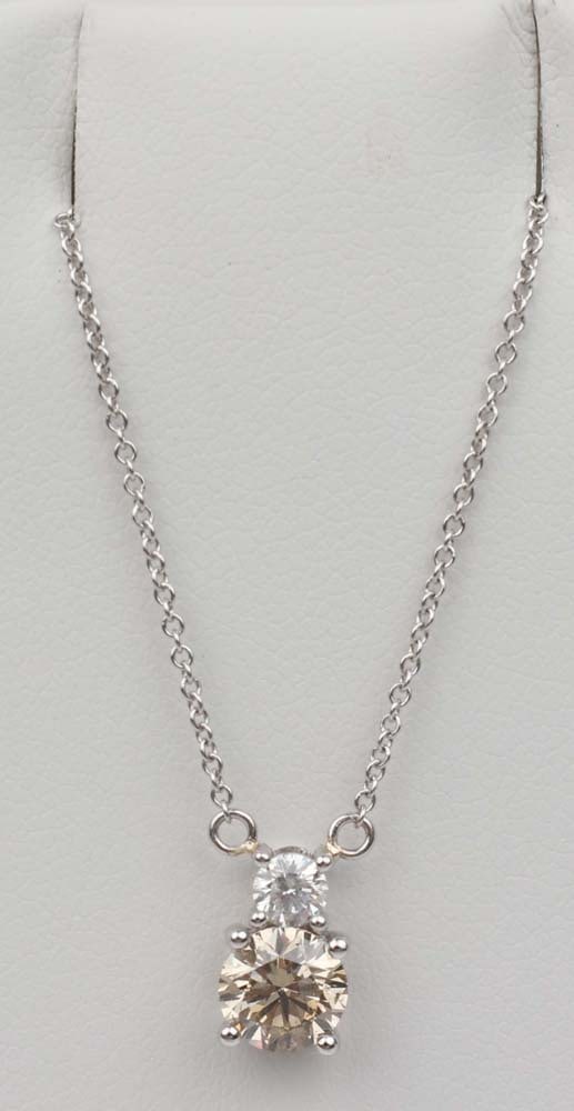 18K WHITE GOLD CHAMPAGNE & WHITE DIAMOND NECKLACE: 18K White Gold Champagne Diamond and White Diamond Necklace. One brilliant round Champagne diamond .81 ct. TLB, Vs2 clarity with an accent brilliant round diamond .16ct. Length: 16" Chain. Pendant 0.5