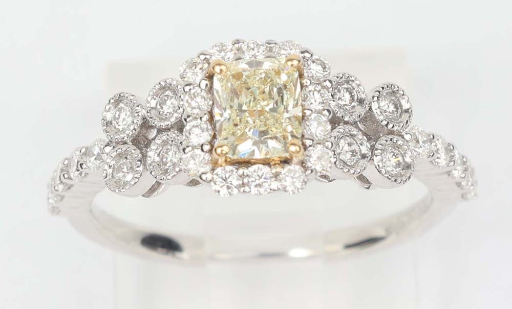 18K WHITE GOLD DIAMOND FANCY YELLOW RING: 18K White gold yellow and white Diamond ring by designer Michael Christoff Gemstones: Diamonds 1 cushion cut diamond .50 ct UVW color /SI1clarity 32 round diamonds .52 ct. G Color-Vs clarity Size