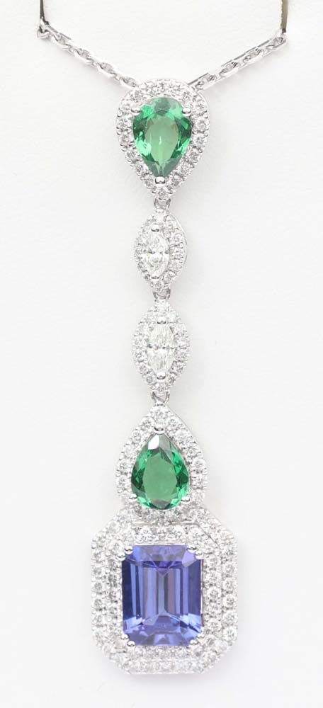 18K DIAMOND TSAVORITE GARNET TANZANITE NECKLACE: 18K White gold Tanzanite, Tsavorite garnet and Diamond pendant exceptional quality. Gemstones: Diamond, Tanzanite and Tsavorite Garnet2 Marquise diamonds .1.02ct H / Vs & SI1 2 Tsavorite garnets pair
