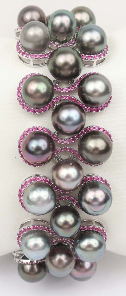 18K WHITE GOLD BLACK PEARL & RUBY BRACELET: 18K White gold Pearl and Ruby Bracelet by Michael Christoff. Gemstones: Pearls and Rubies 38 black pearls 6 to 8 mm646 round rubies 6.19 ct. Size 7" Weight: 30 grams plus gem weight. Overall