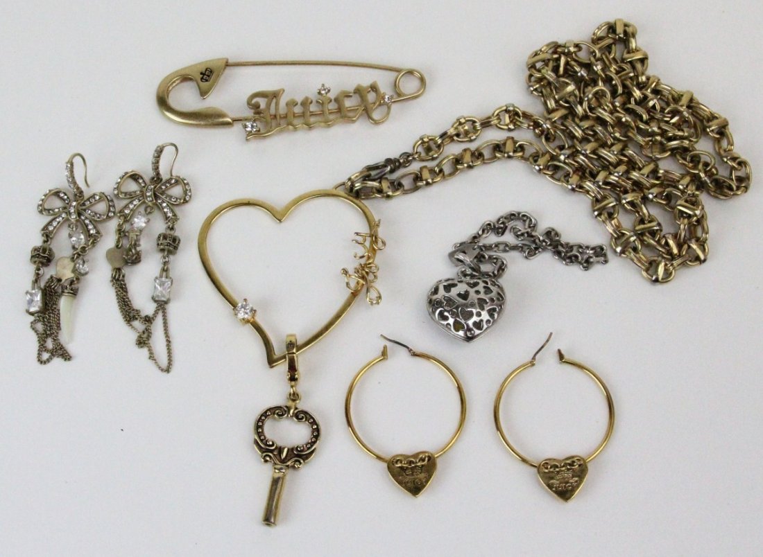 (5) PIECES OF JUCY COUTURE JEWELRY: (5) PIECES OF JUCY COUTURE JEWELRY Five pieces of Juicy Couture designer jewelry, mostly gold toned. Chain with heart pendant and key charm; hoop heart earrings; large safety pin; bow earrings with da