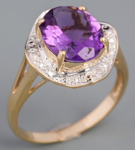 YELLOW GOLD OVAL AMETHYST FASHION RING: YELLOW GOLD OVAL AMETHYST FASHION RING Oval cut 9x11mm amethyst, set in a two tone 10K yellow gold illusion setting. Weight: 3.1 g Size: 7.25
