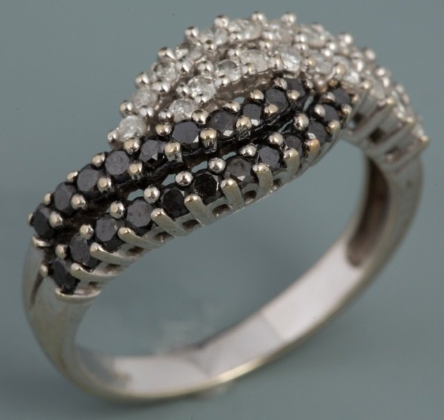 BLACK AND WHITE DIAMOND RING: BLACK AND WHITE DIAMOND RING 10K white gold black and white diamond ring. Forty-three diamonds in total, weighing approximately .03ct each. 1.32 ct total weight. Weight: 3.2 g Size: 7.75