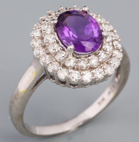 WHITE GOLD AMETHYST AND DIAMOND COCKTAIL RING: WHITE GOLD AMETHYST AND DIAMOND COCKTAIL RING 1.65CT oval amethyst surrounded with two halos of diamonds. Estimated total diamond weight of 1.15ct. Weight: 5.2 g Size: 8.75