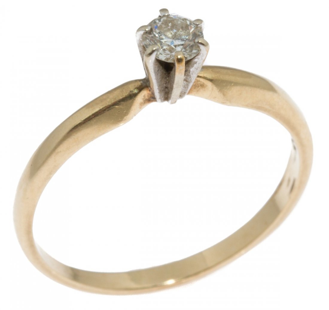 LADIES 14K GOLD DIAMOND SOLITAIRE ENGAGEMENT RING: LADIES 14K GOLD DIAMOND SOLITAIRE ENGAGEMENT RING Ladies solitaire engagement ring. Approximately a 0.25 ct round cut diamond of SI clarity and I-K color. 14K yellow gold band with white gold prongs. 
