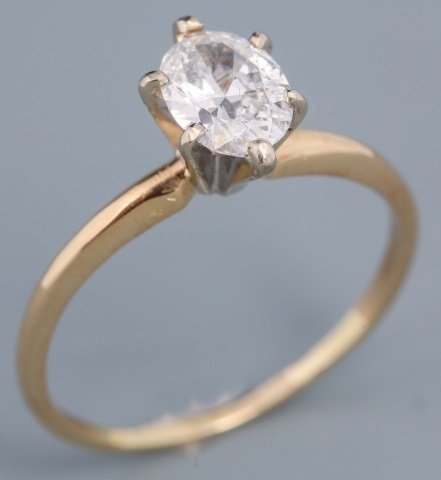 14K YELLOW GOLD OVAL CUT DIAMOND SOLITAIRE: 14K YELLOW GOLD OVAL CUT DIAMOND SOLITAIRE Oval cut diamond, weighing .71 ct, with G color and SI clarity, set in a six prong, 14K yellow gold solitaire setting. Weight: 1.9 g Size: 7