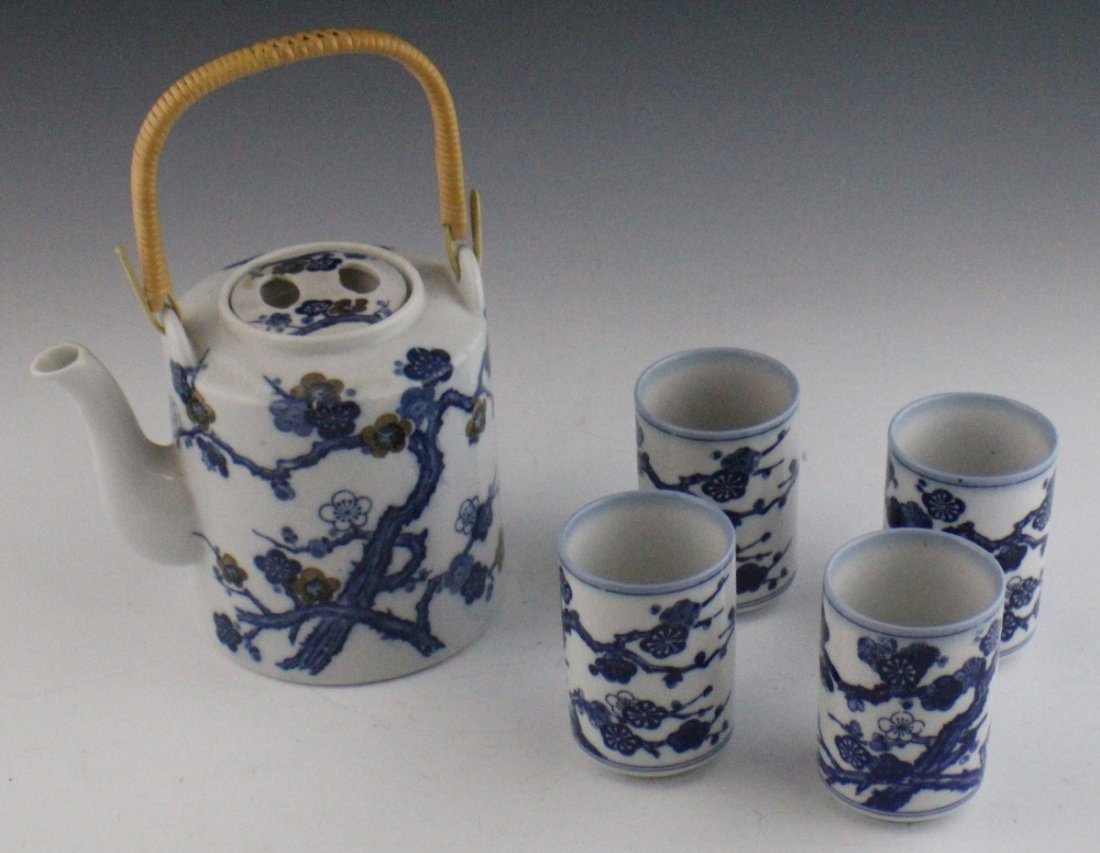 BLUE AND WHITE TAKAHASHI JAPANESE TEA SET: BLUE AND WHITE TAKAHASHI JAPANESE TEA SET Takahashi ceramic tea set, made in Japan. Features blue and white cherry blossom pattern. Includes lidded teapot with bamboo handle and four matching cups. Si