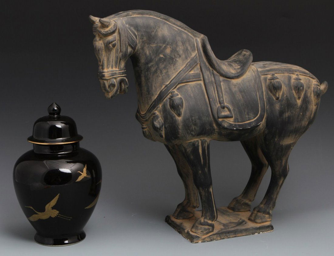 DECORATIVE GINGER JAR AND TERRACOTTA HORSE: DECORATIVE GINGER JAR AND TERRACOTTA HORSE Mixed lot of decorative asian items. A black glazed Japanese lidded ginger jar made by Sadek with gold flying cranes. A large Tang Dynasty terracotta clay wa