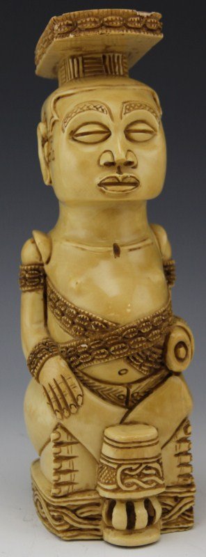 AFRICAN IVORY FEMALE FERTILITY FIGURE: AFRICAN IVORY FEMALE FERTILITY FIGURE Ivory African lady with repeated cowry shell design representing fertility and the symbol of Africa. Female is sitting in front of a drum with something in her le