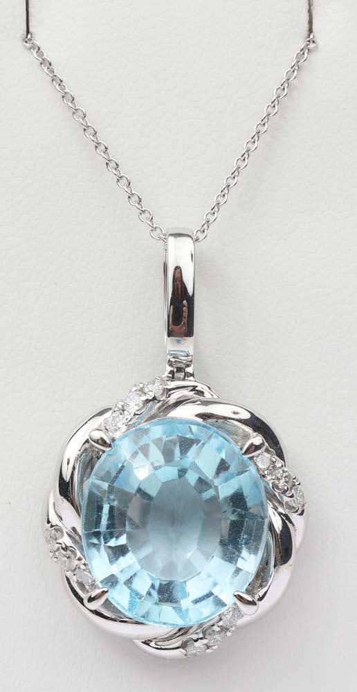 14K WHITE GOLD BLUE TOPAZ & DIAMOND PENDANT: 14k white gold blue topaz & Diamond Pendant. Designer Michael Christoff. Gemstones: Blue Topaz & Diamond 12 round diamonds .25ctOne Blue topaz 13.67 ct. 14k white gold. Length: 18" Weight: 8.0 grams