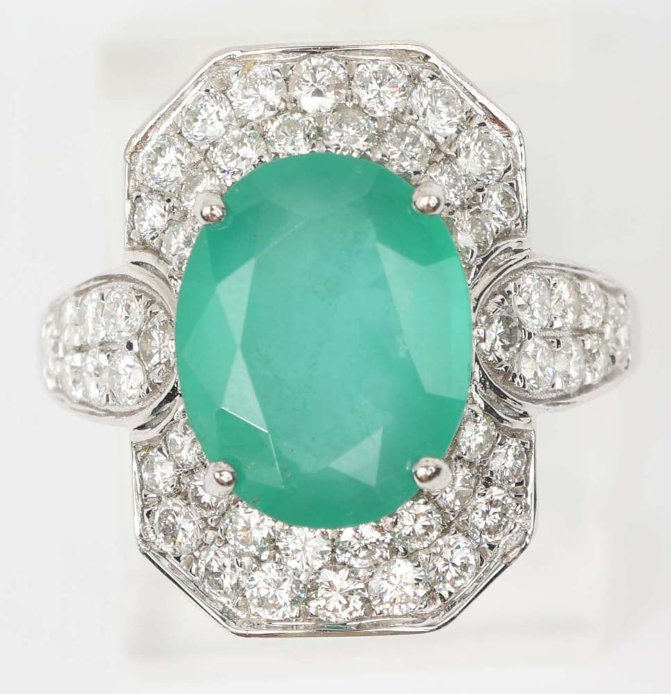 14K WHITE GOLD EMERALD & DIAMOND RING: 14k white gold Emerald & Diamond Ring. Designer Michael Christoff. Gemstones: Emerald & Diamond 50 round diamonds 1.07 ct.One oval Columbian Emerald 2.32 ct. 14k white gold. Size: 6.75 Weight: 3.8
