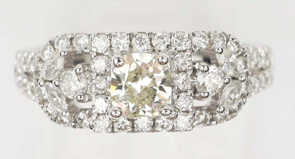 18K WHITE GOLD FANCY YELLOW DIAMOND RING: 18k white and yellow gold fancy yellow diamond ring. Designer Michael Christoff. Gemstones: Fancy top champagne & white diamondsMarquise and round diamonds .76 ct. Cushion cut I1 diamond .58 ct. 18k w