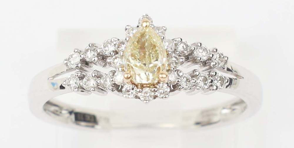 18K WHITE GOLD FANCY YELLOW DIAMOND RING: 18k white and yellow gold fancy yellow diamond ring. Designer Michael Christoff. Gemstones: Fancy Yellow & white diamonds 24 round diamonds .21ctOne fancy yellow diamond .29 ct. 14k white gold Size: 6