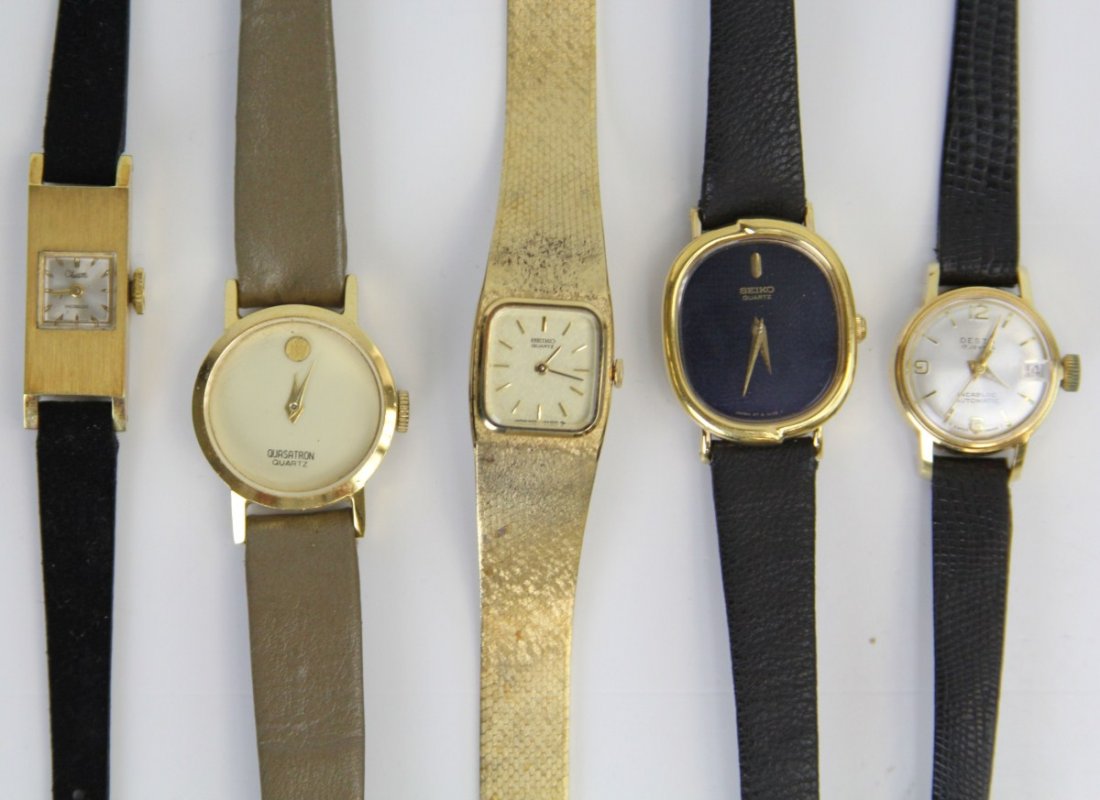 FIVE WOMENS WRISTWATCHES: FIVE WOMENS WRISTWATCHES Five Woman Wristwatches. A Seiko quartz with black face and gold hour and minute hands with black band, a Seiko quartz with gold baton numeral,hour and minute hand and band, a