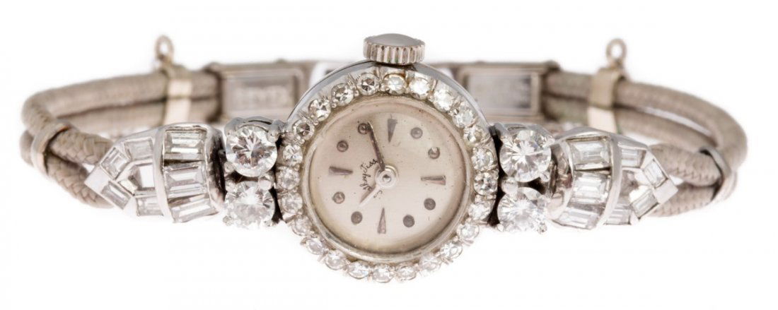 VINTAGE MATHEY-TISSOT DIAMOND PLATINUM WATCH: VINTAGE MATHEY-TISSOT DIAMOND PLATINUM WATCH Ladies vintage diamond and platinum watch by Mathey-Tissot, approximately 1.25 CTW. Round case, diamond bezel, ribbon band. Weight: 12.2g Size: 13mm