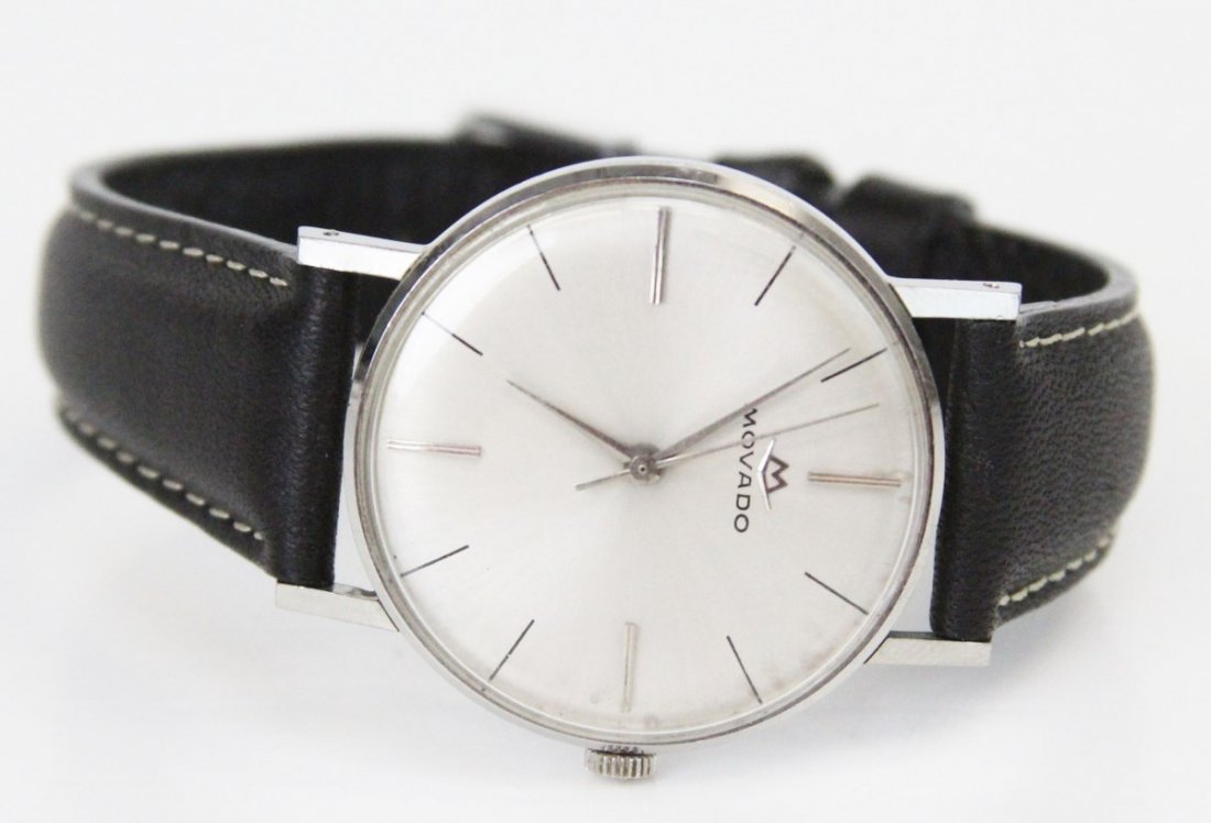 MOVADO MEN'S MANUAL WRISTWATCH: MOVADO MEN'S MANUAL WRISTWATCH Manual men's Movado 17 Jewel movement wrist watch, shell white dial with silver tone baton numerals and hands. Black genuine leather band. In working order, however this