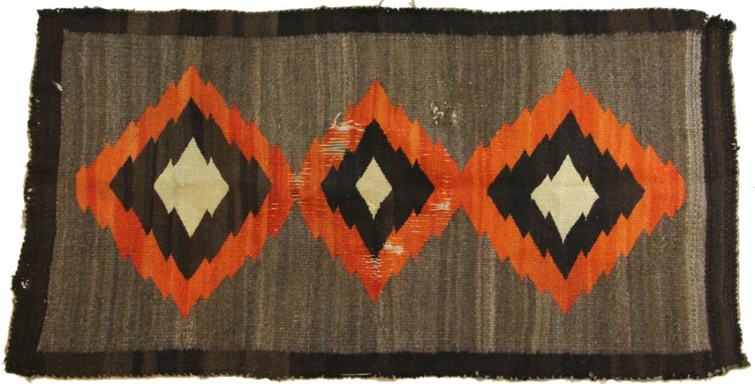 EARLY 20TH CENTURY HAND WOVEN NAVAJO RUG: EARLY 20TH CENTURY HAND WOVEN NAVAJO RUG Authentic hand woven Navajo rug, circa early 20th C, Grey with dark brown border and three orange, brown, and white diamond elements; Significant wear to cente